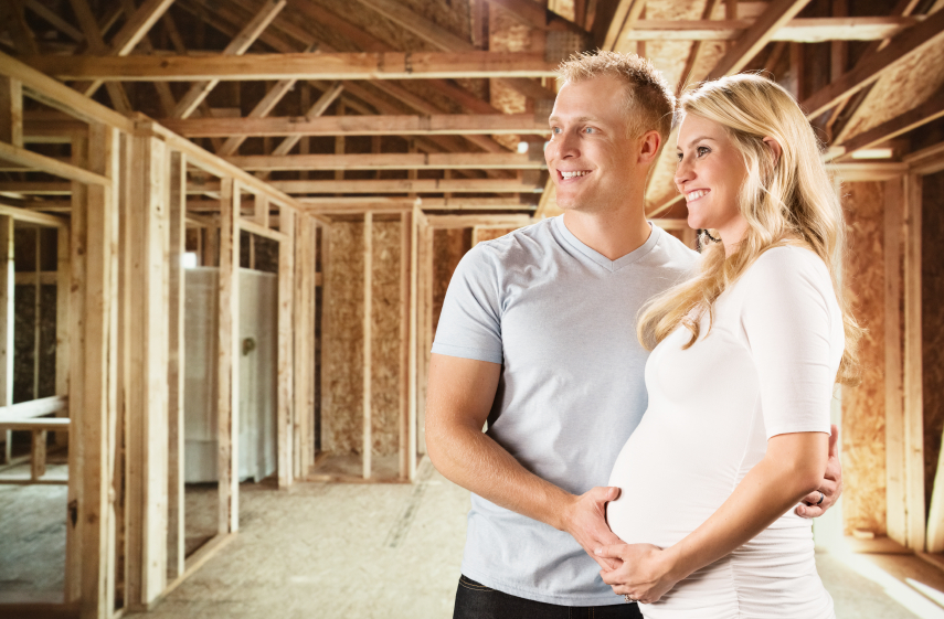 Construction-Contractors-Toronto-Smiling-Young-Pregnant-Couple-in-New-Home-Construction-Site
